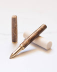 Feathered Walnut handmade Studio Pen with a brass grip and a refillable roller ball