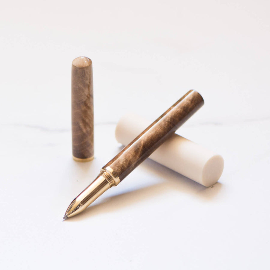 Feathered Walnut handmade Studio Pen with a brass grip and a refillable roller ball