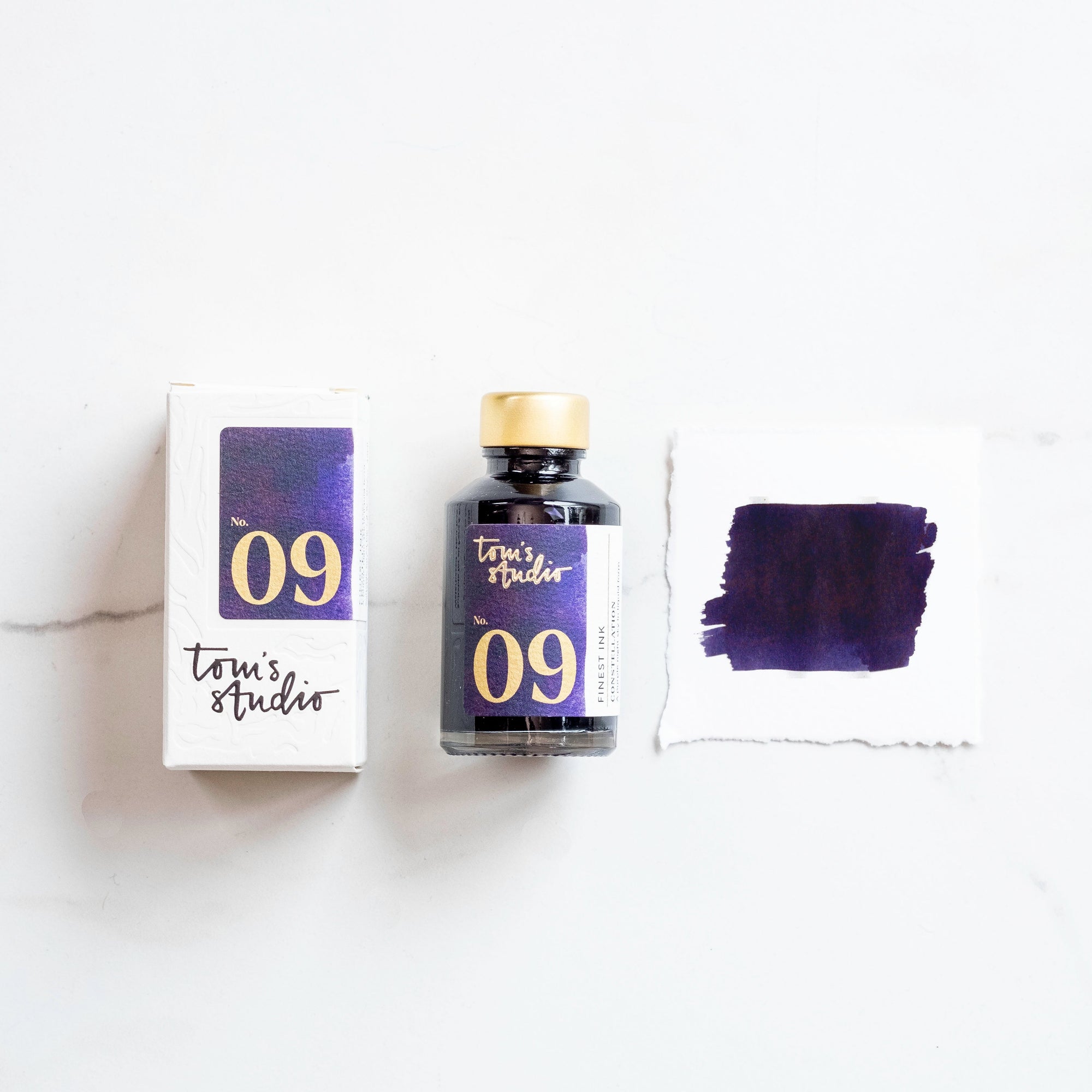 Tom's Studio Constellation Fountain Pen Ink – featuring the packaging, bottle and a swatch on paper