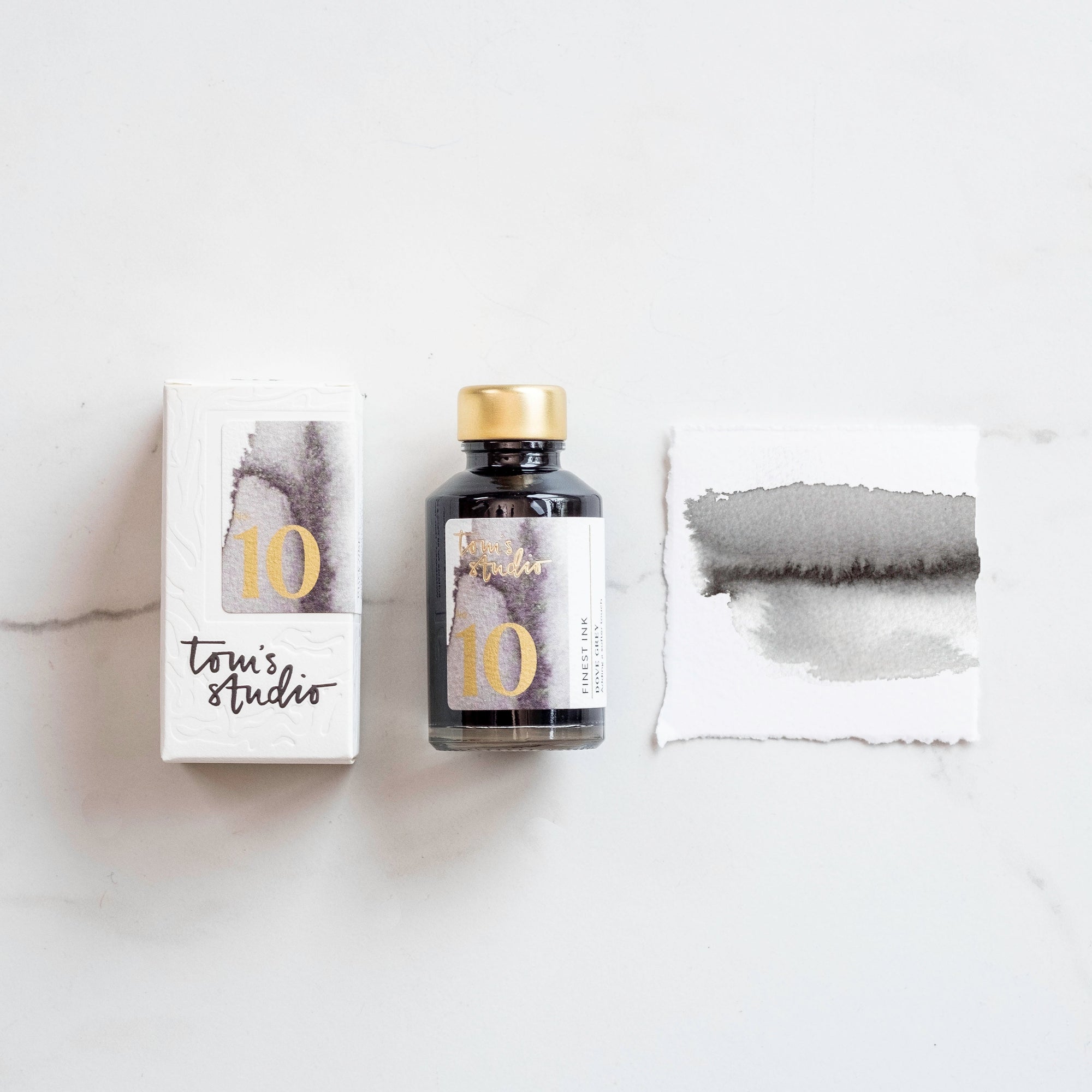 Tom's Studio Dove Grey Fountain Pen Ink – featuring the packaging, bottle and a swatch on paper