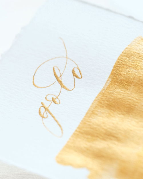 Gold calligraphy ink on a piece of paper