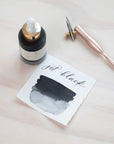 Jet Black - Calligraphy Ink in bottle with swatch showing the ink colour