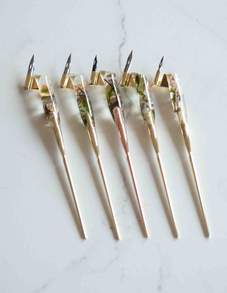 Ocean Calligraphy Pen five pens in a row on a marble background