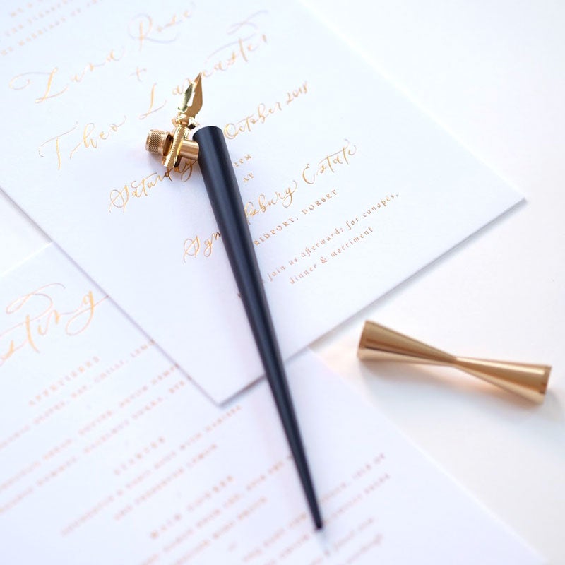 The Original Flourish Oblique Calligraphy Pen in Black with Butterfly Brass Pen Rest and sample of calligraphy