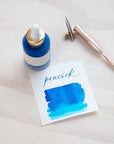 Peacock - Calligraphy Ink in bottle with swatch showing the ink colour