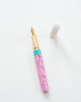 Pink + Turquoise - Studio Fountain pen on a white desk open showing the flexible fountain pen nib