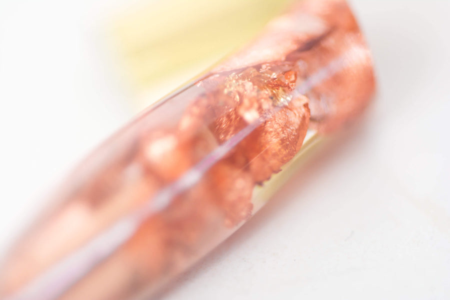 Rose gold flecks in the grip of a hand made oblique calligraphy pen