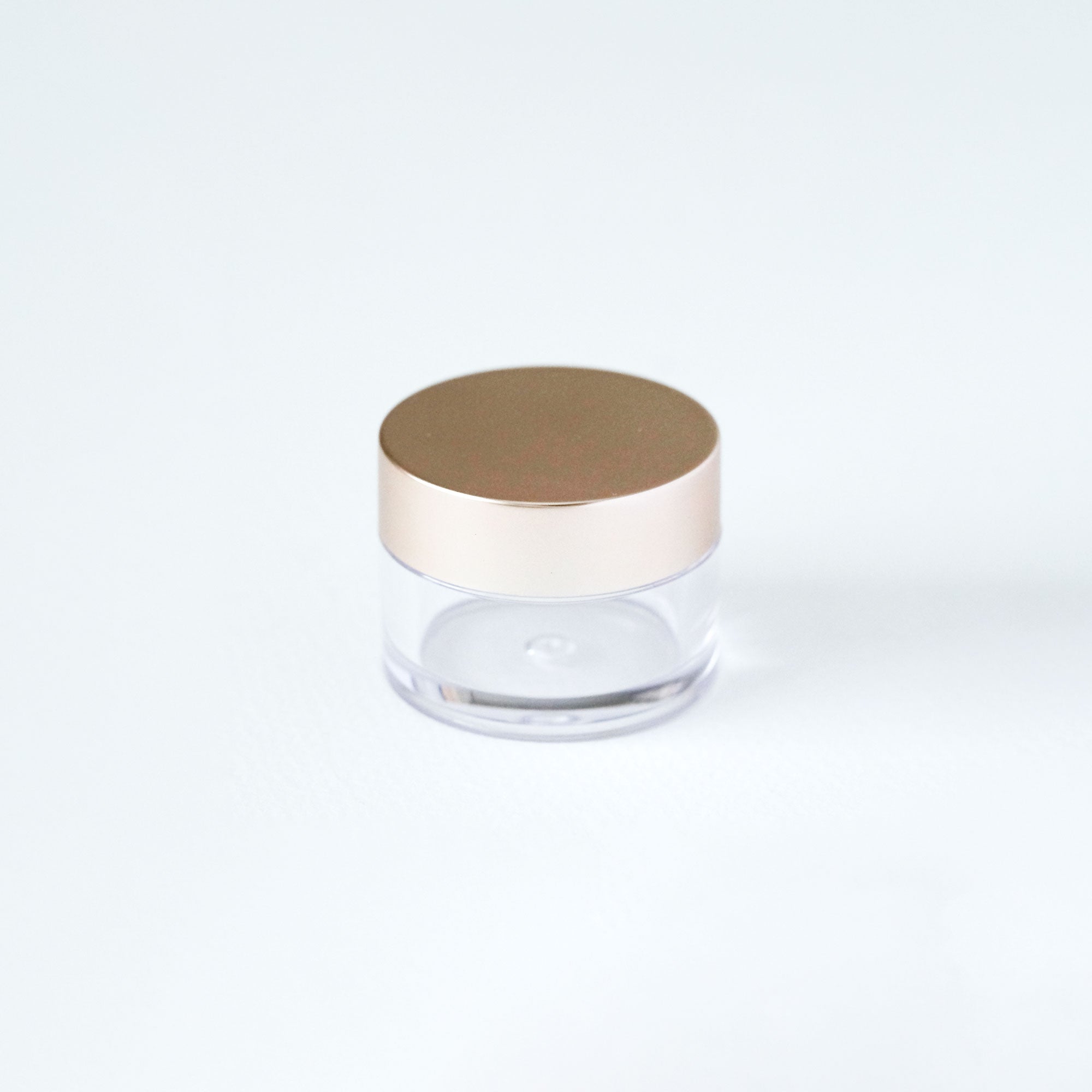 Clear ink pot with a rose gold lid