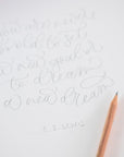 Cursive writing in pencil on cartridge paper with a scented pencil