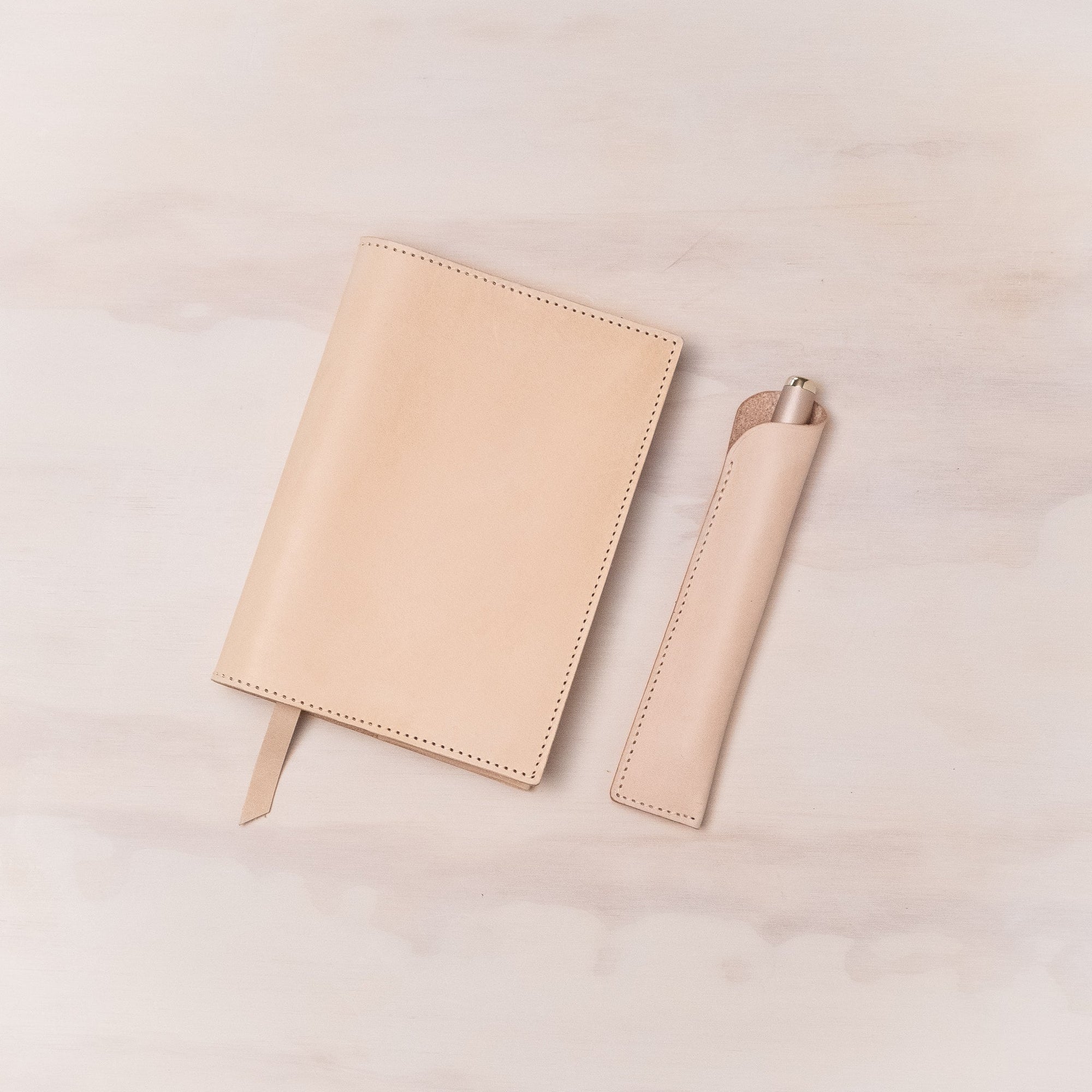 Leather Pen Sleeve for the Lumos Pro in Natural shown with matching leather notebook cover and the Studio Fountain Pen in Blush