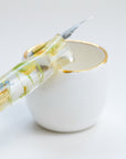 Fine Bone China Artist's Ink Well by Wendy Tournay with a calligraphy pen resting on it