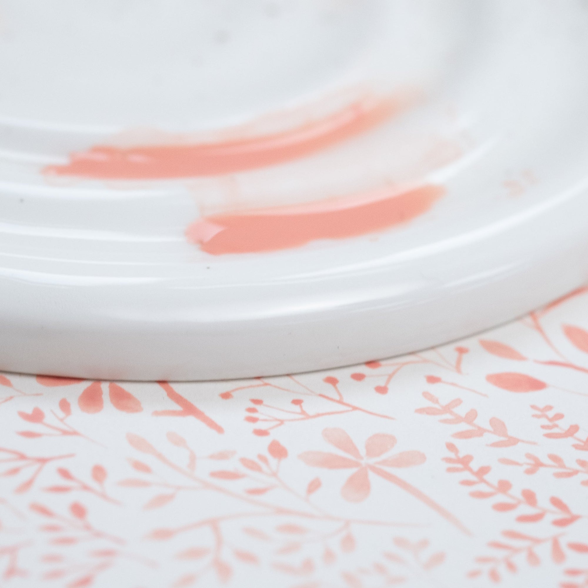 Detail shot of the Fine Bone China Artist's Palette by Wendy Tournay with paint on and watercolour background